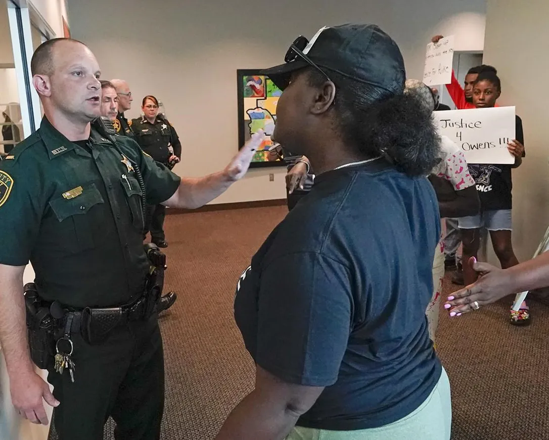 A protester, right, confronts a Marion County sheriff deputy at the Marion County Courthouse, Tuesday, June 6, 2023, in Ocala, demanding the arrest of a woman who shot and killed Ajike Owens, a 35-year-old mother of four, last Friday night, June 2. Authorities came under intense pressure Tuesday to bring charges against a white woman who killed Owens, a Black neighbor, on her front doorstep, as they navigated Florida’s divisive stand your ground law that provides considerable leeway to the suspect in making a claim of self defense.