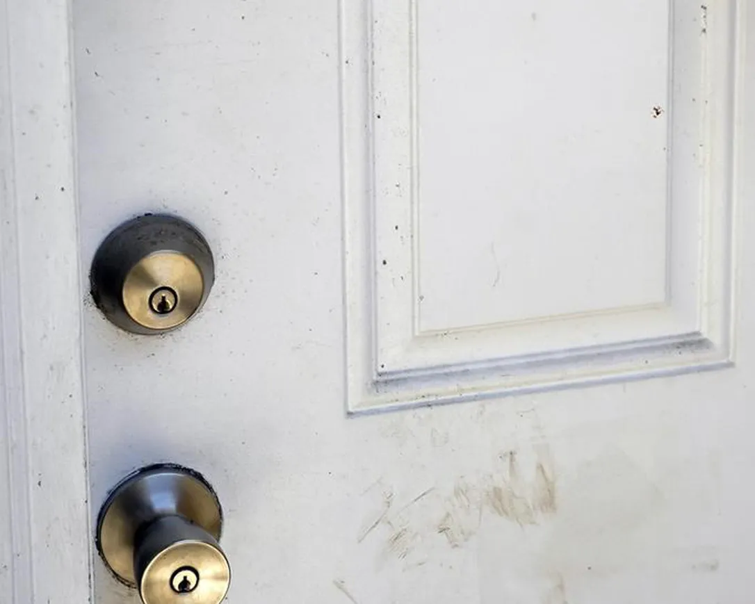 A patched bullet hole, upper right, is seen on a door, Tuesday, June 6, 2023, where Ajike Owens, a 35-year-old mother of four, was shot and killed the week before, moments after going to the apartment of her neighbor who had yelled at Owens' children as they played in a nearby lot, in Ocala, Fla.