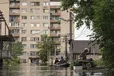 A man gets to his flooded house in Kherson, Ukraine, Thursday, June 8, 2023. Floodwaters from a collapsed dam kept rising in southern Ukraine on Wednesday, forcing hundreds of people to flee their homes in a major emergency operation that brought a dramatic new dimension to the war with Russia, now in its 16th month.
