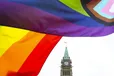 A Pride flag flies on Parliament Hill in Ottawa on Thursday, June 8, 2023, during a Pride event. Canada has partnered with a non-profit to seek out LGBTQI+ refugees fleeing violence all over the world and refer them to Canada as government-assisted refugees.