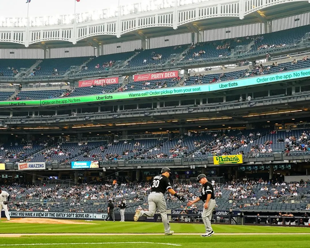 Chicago White Sox's Jake Burger (30) celebrates with third base coach Eddie Rodriguez as he runs the bases after hitting a two-run home run during the second inning in the first baseball game of a doubleheader against the New York Yankees Thursday, June 8, 2023, in New York.
