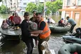 Volunteers help to unload a disabled local resident from a boat during an evacuation from a flooded area in Kherson on Thursday.