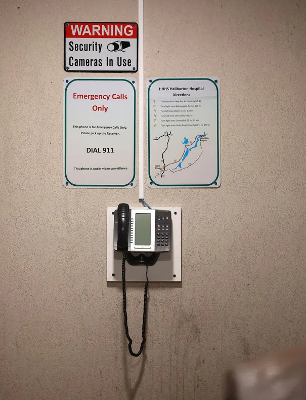 A telephone with signage that directs emergency patients to call 9-1-1 has been installed by the entrance to the Minden emergency department.
