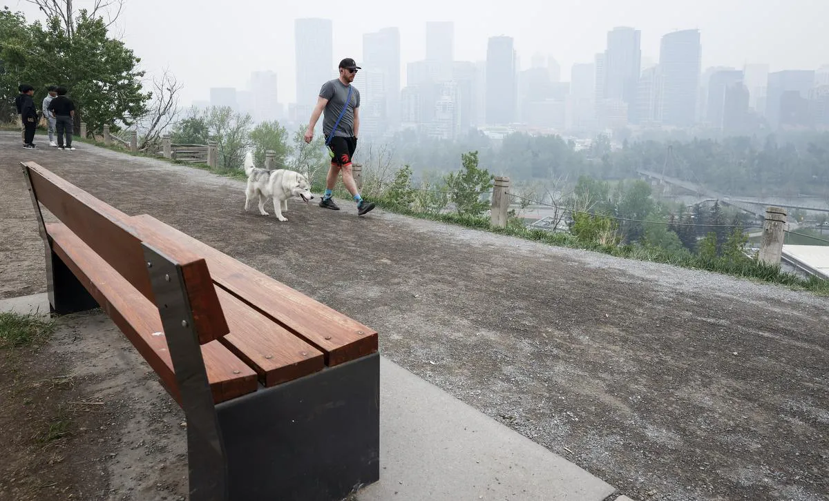 Thick smoke from wildfires blankets the downtown in Calgary last month.