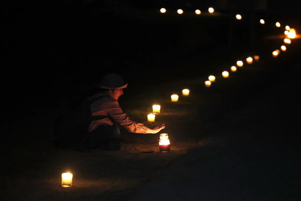 Candles light the path during the vigil outside the Minden emergency department.