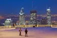 Cross-country skiers stop to admire the view of Montreal from one of the lookouts on Mont Royal. 